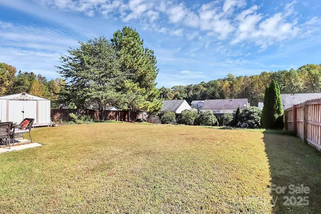 a view of a house with yard and sitting area