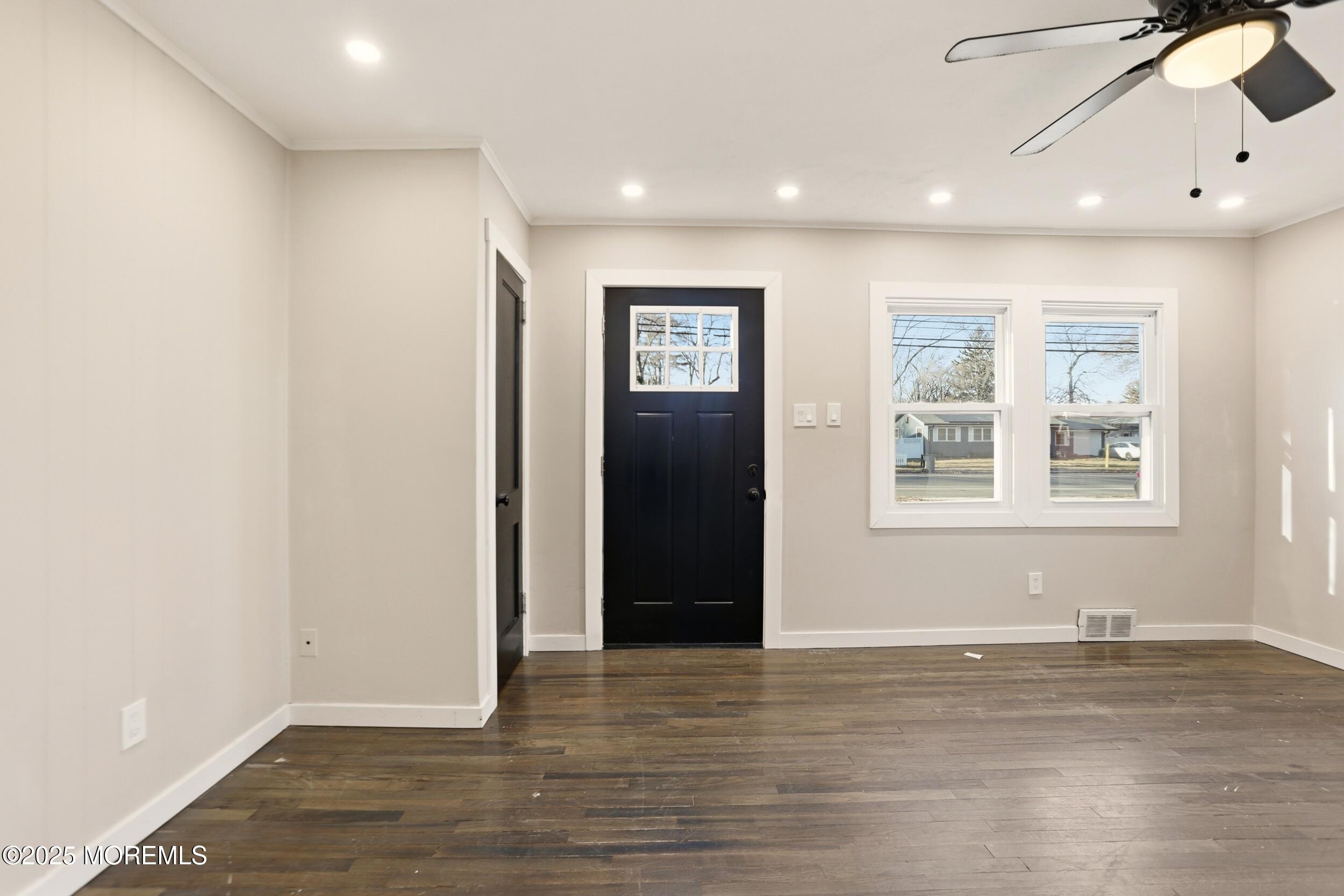 22 Oak Ridge Parkway Toms River, NJ 08755 - Photo 14 of 28 an empty room with wooden floor and windows