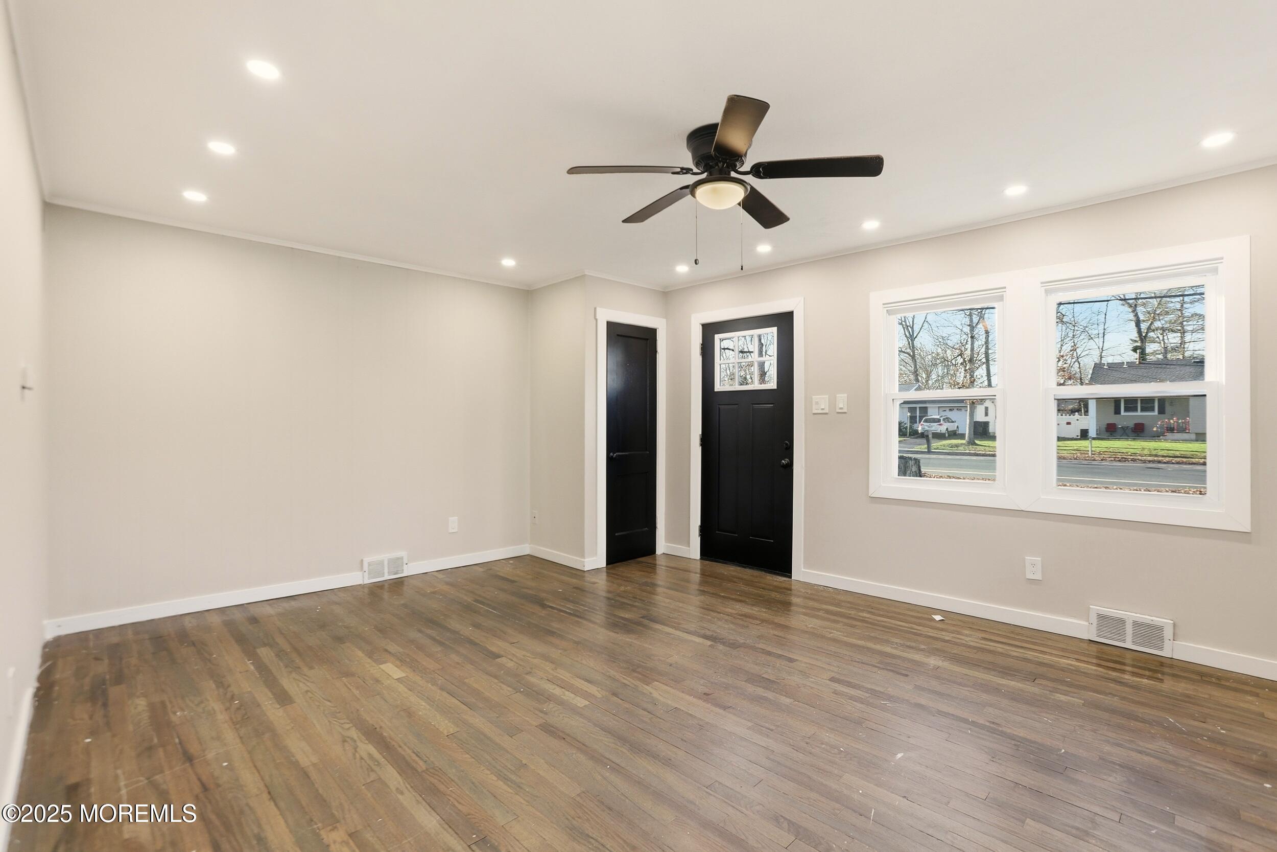 22 Oak Ridge Parkway Toms River, NJ 08755 - Photo 15 of 28 a view of an empty room with window and wooden floor
