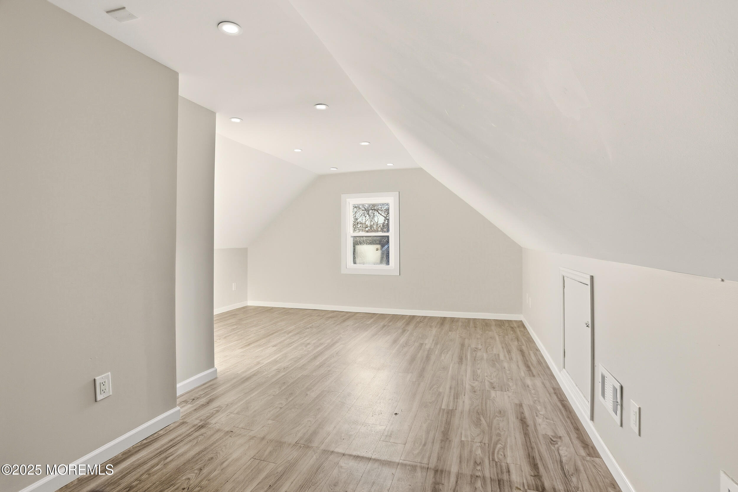 22 Oak Ridge Parkway Toms River, NJ 08755 - Photo 18 of 28 a view of an empty room with wooden floor and a window