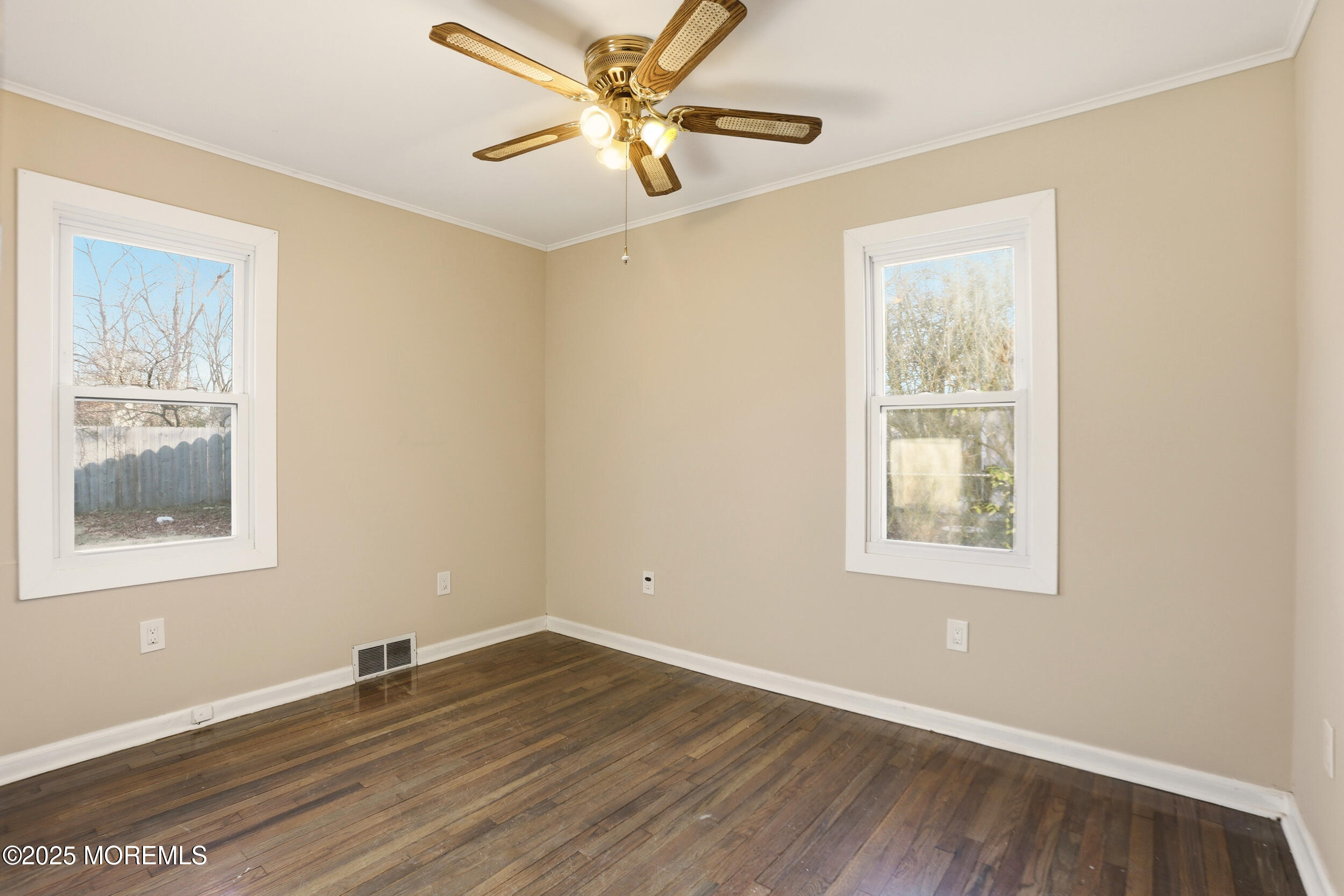22 Oak Ridge Parkway Toms River, NJ 08755 - Photo 20 of 28 a view of an empty room with wooden floor and a window