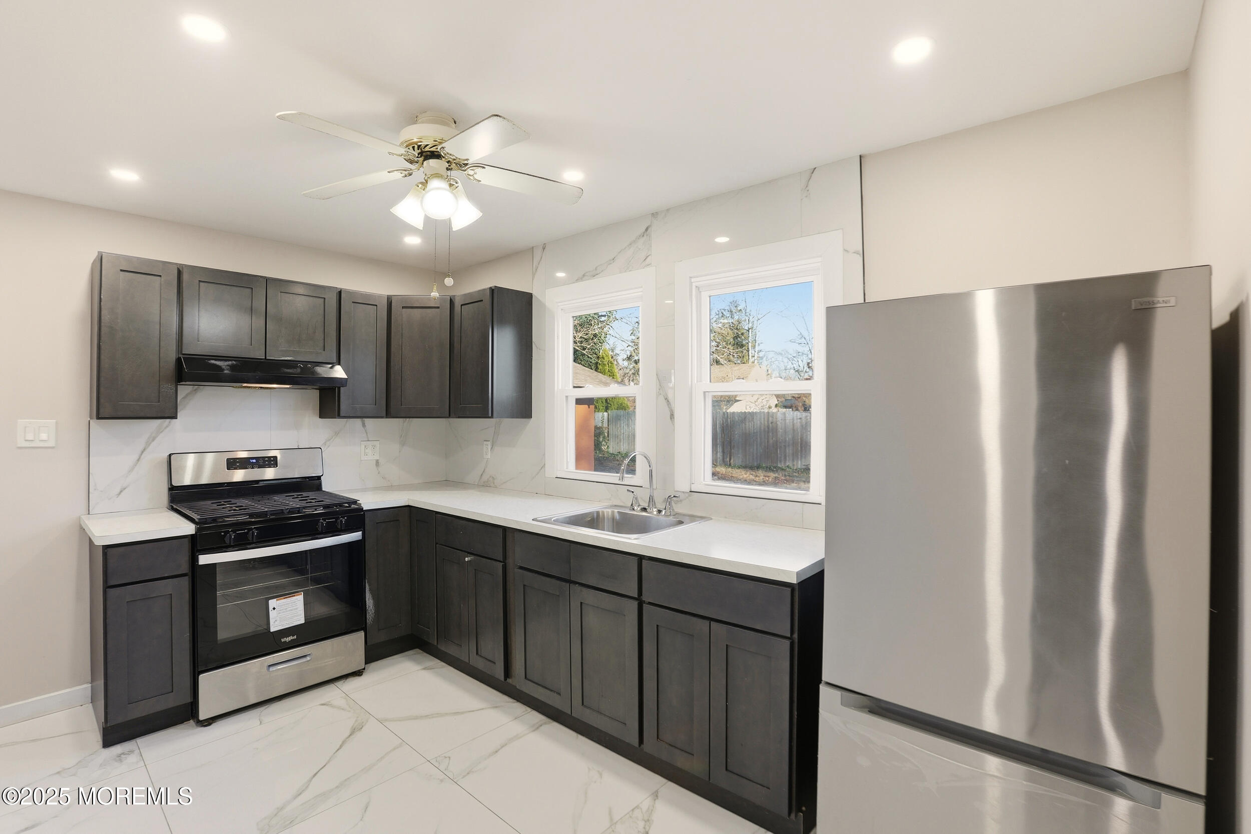 22 Oak Ridge Parkway Toms River, NJ 08755 - Photo 7 of 28 a kitchen with kitchen island granite countertop stainless steel appliances cabinets a sink and a counter top space