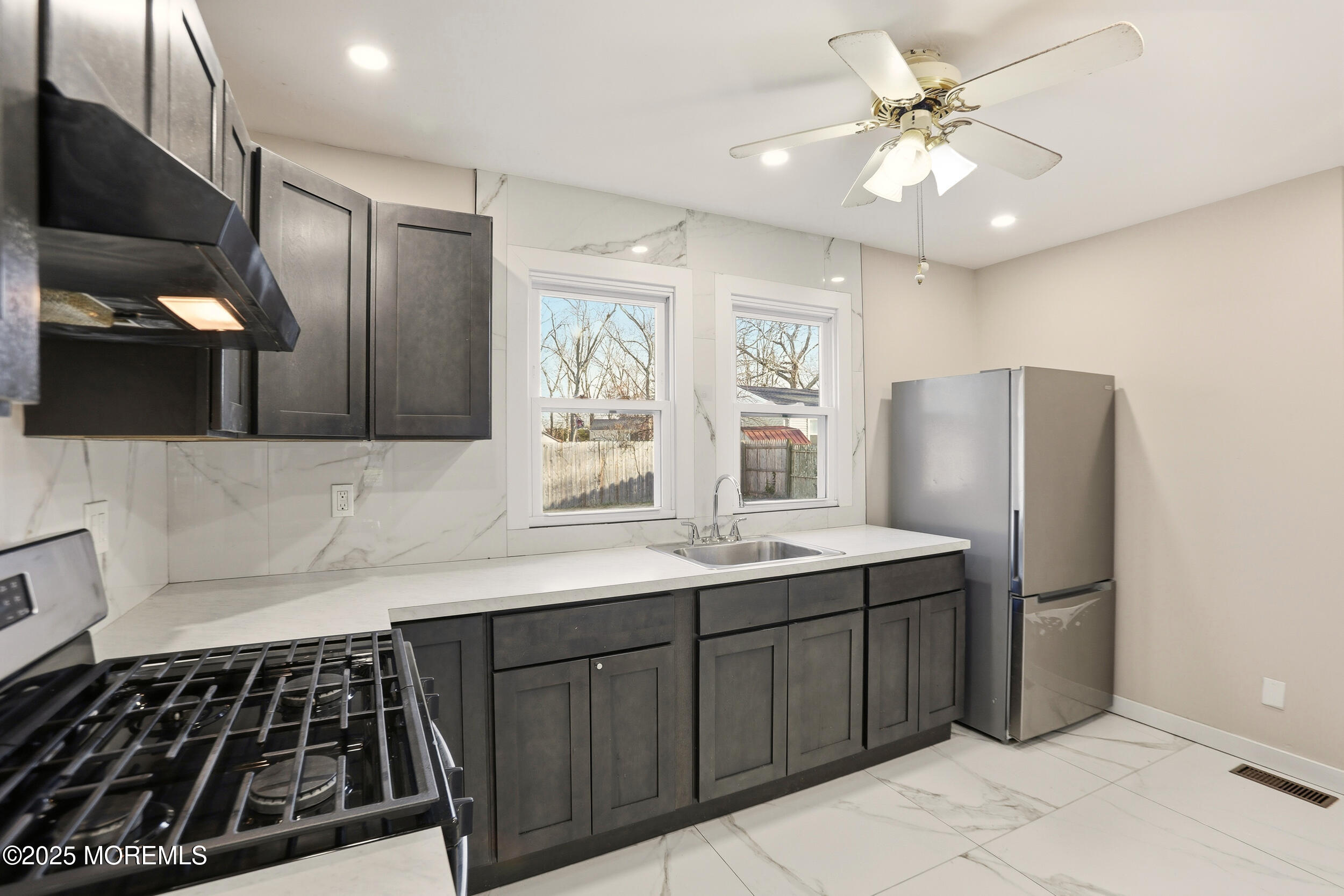 22 Oak Ridge Parkway Toms River, NJ 08755 - Photo 9 of 28 a kitchen with stainless steel appliances a sink stove and refrigerator
