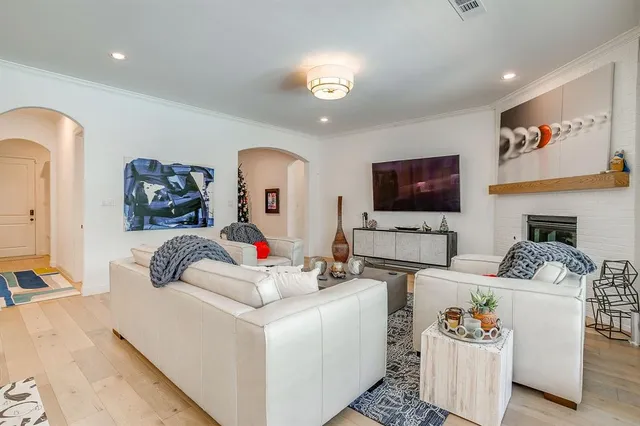 a living room with fireplace furniture and a flat screen tv
