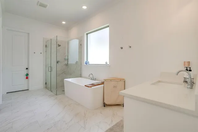 a bathroom with a sink mirror and a bathtub