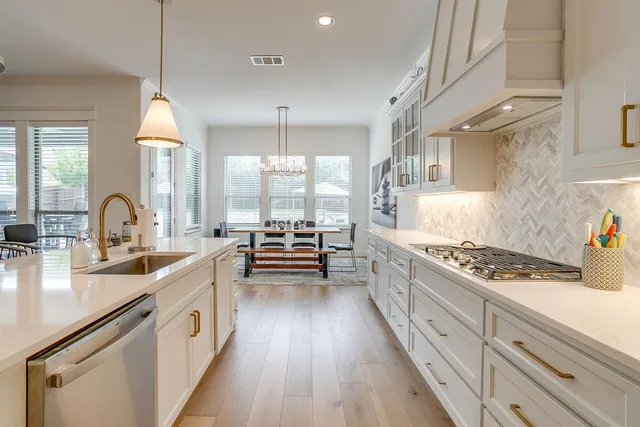 a kitchen with counter top space a sink stainless steel appliances and cabinets