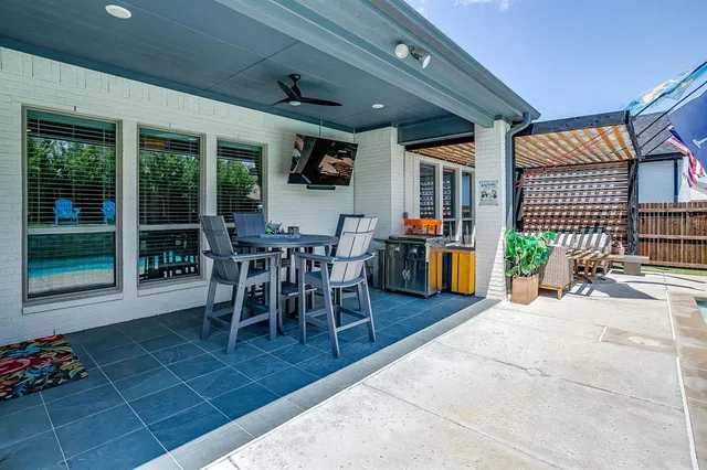 a view of a dining room with furniture and chandelier