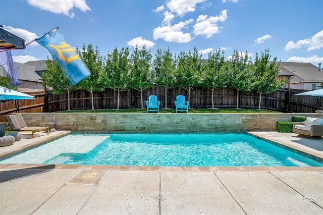 a front view of a house with a yard and potted plants