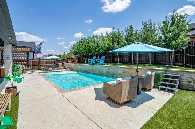 a view of a house with backyard and sitting area
