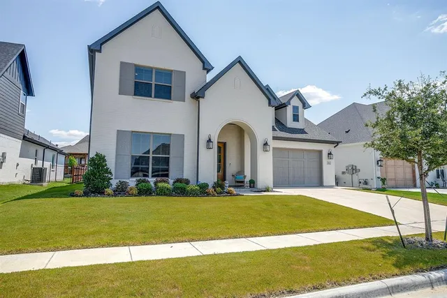 a view of a house with a big yard and large trees