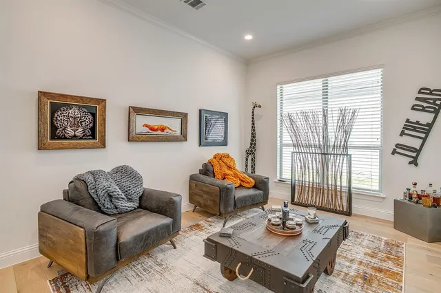 a living room with furniture and a floor to ceiling window