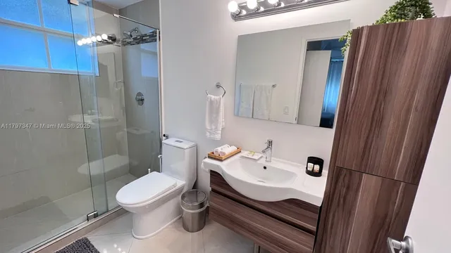 a bathroom with a sink toilet and shower