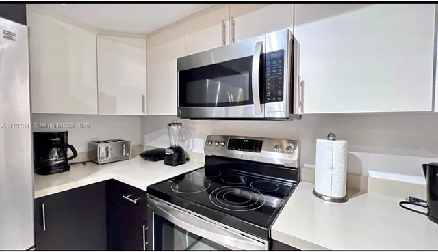 a kitchen with a stove and a microwave