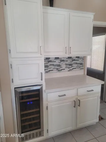 a kitchen with white cabinets and appliances
