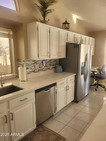 a kitchen with cabinets and window