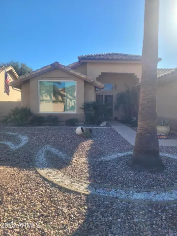 a view of a grey house with a yard