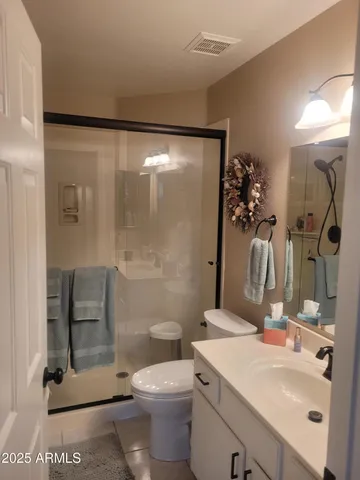 a view of a bedroom with a bed and glass door