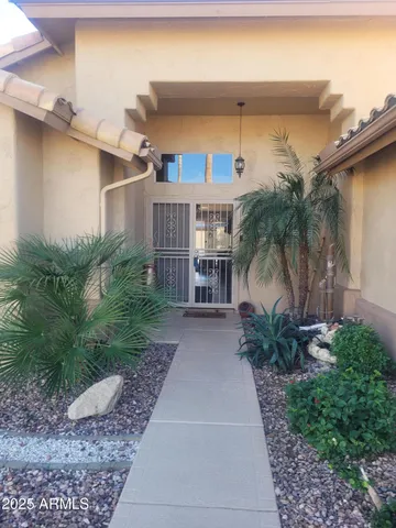 a couple of potted plants in front of door