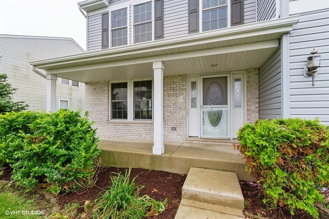 2224 Ridge Drive Hebron, IL 60034 - Photo 5 of 29 front view of a brick house with potted plants