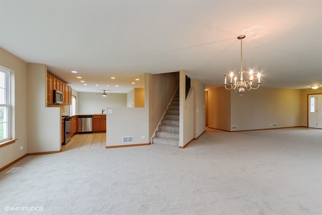 2224 Ridge Drive Hebron, IL 60034 - Photo 9 of 29 a view of a livingroom with a chandelier furniture and windows
