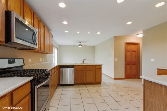 2224 Ridge Drive Hebron, IL 60034 - Photo 10 of 29 a kitchen with stainless steel appliances granite countertop a stove and a sink