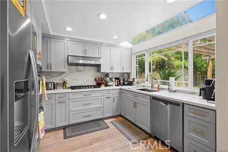19849 Crystal Ridge Lane Porter Ranch, CA 91326 - Photo 15 of 29 a kitchen with a sink window and cabinets