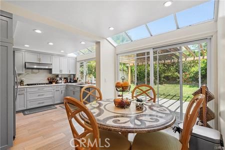 19849 Crystal Ridge Lane Porter Ranch, CA 91326 - Photo 17 of 29 a dining room with furniture a large window and kitchen view