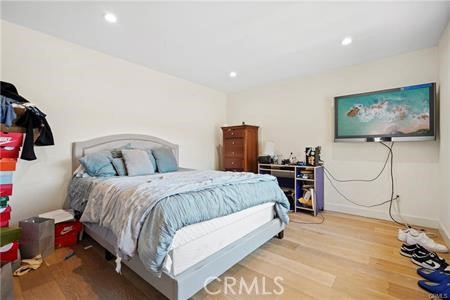 19849 Crystal Ridge Lane Porter Ranch, CA 91326 - Photo 19 of 29 a spacious bedroom with a bed and wooden floor