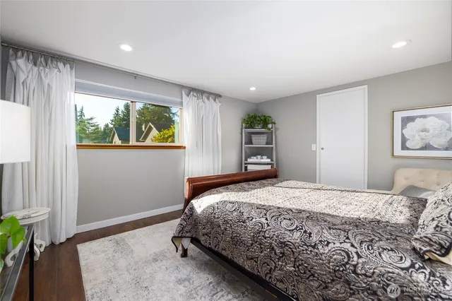 a bedroom with a large bed and a window