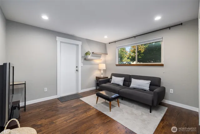 a living room with furniture and a potted plant