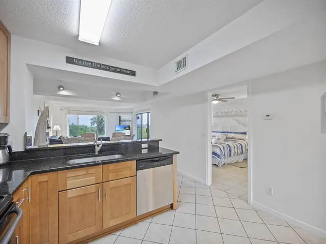 a kitchen with stainless steel appliances a sink and cabinets