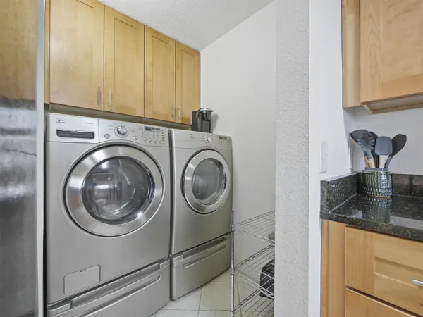 a close view of a utility room with dryer and washer
