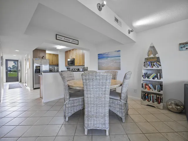 a dining room with furniture and a kitchen view