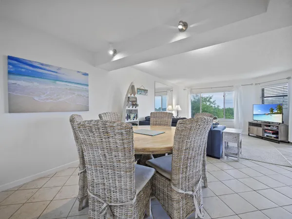 a dining room with furniture and a floor to ceiling window