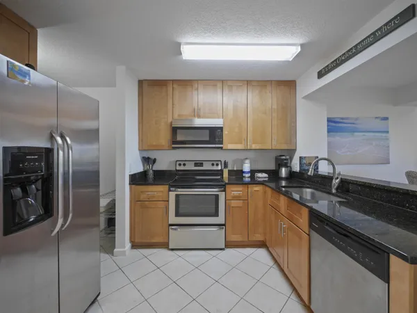 a kitchen with a sink stove and refrigerator
