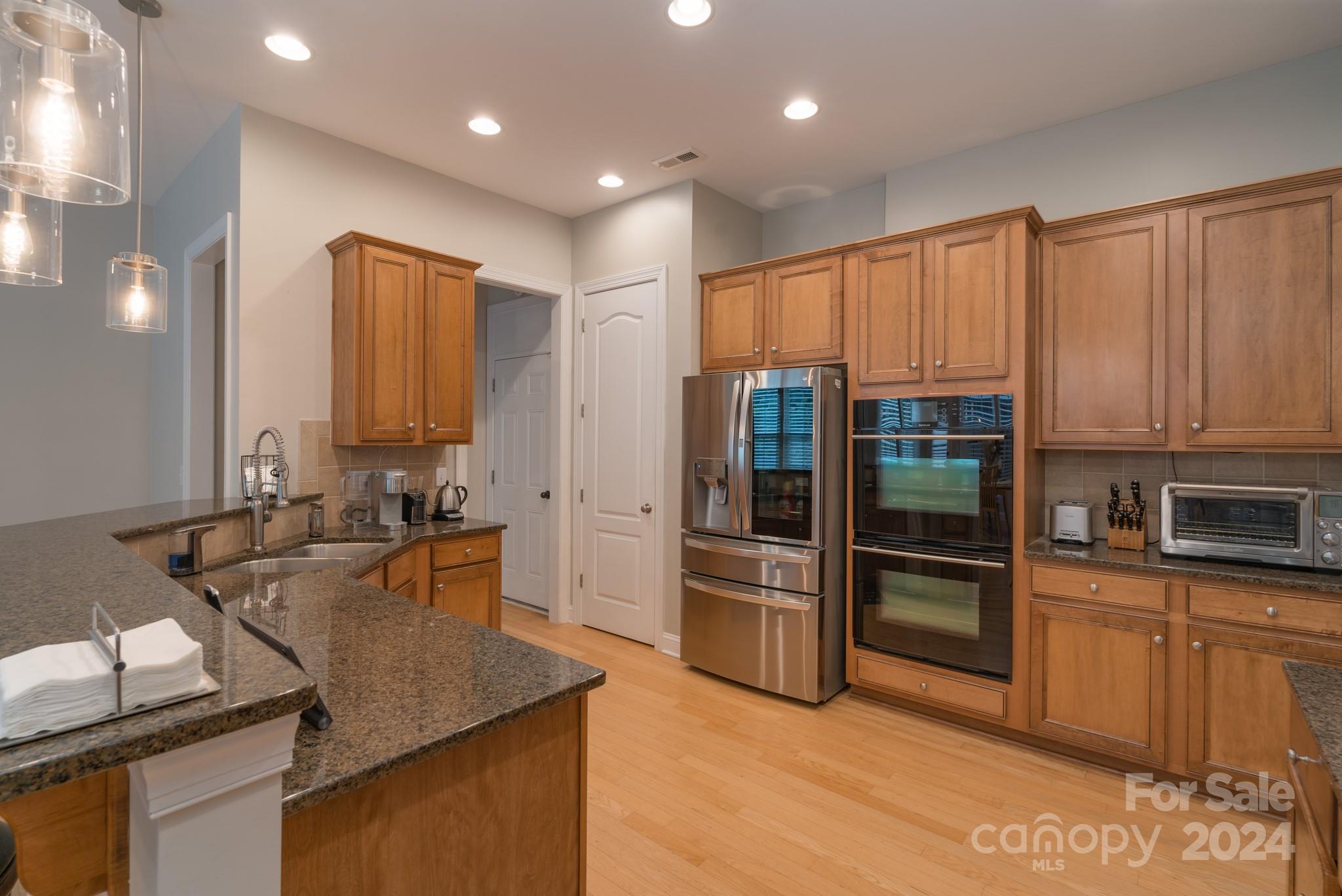 925 Treasure Court Fort Mill, SC 29708 - Photo 18 of 45 a kitchen with kitchen island granite countertop a sink and refrigerator