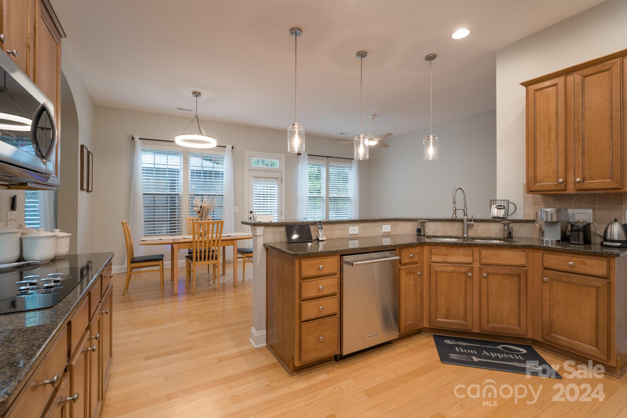 925 Treasure Court Fort Mill, SC 29708 - Photo 20 of 45 a kitchen with lots of counter top space and dining table