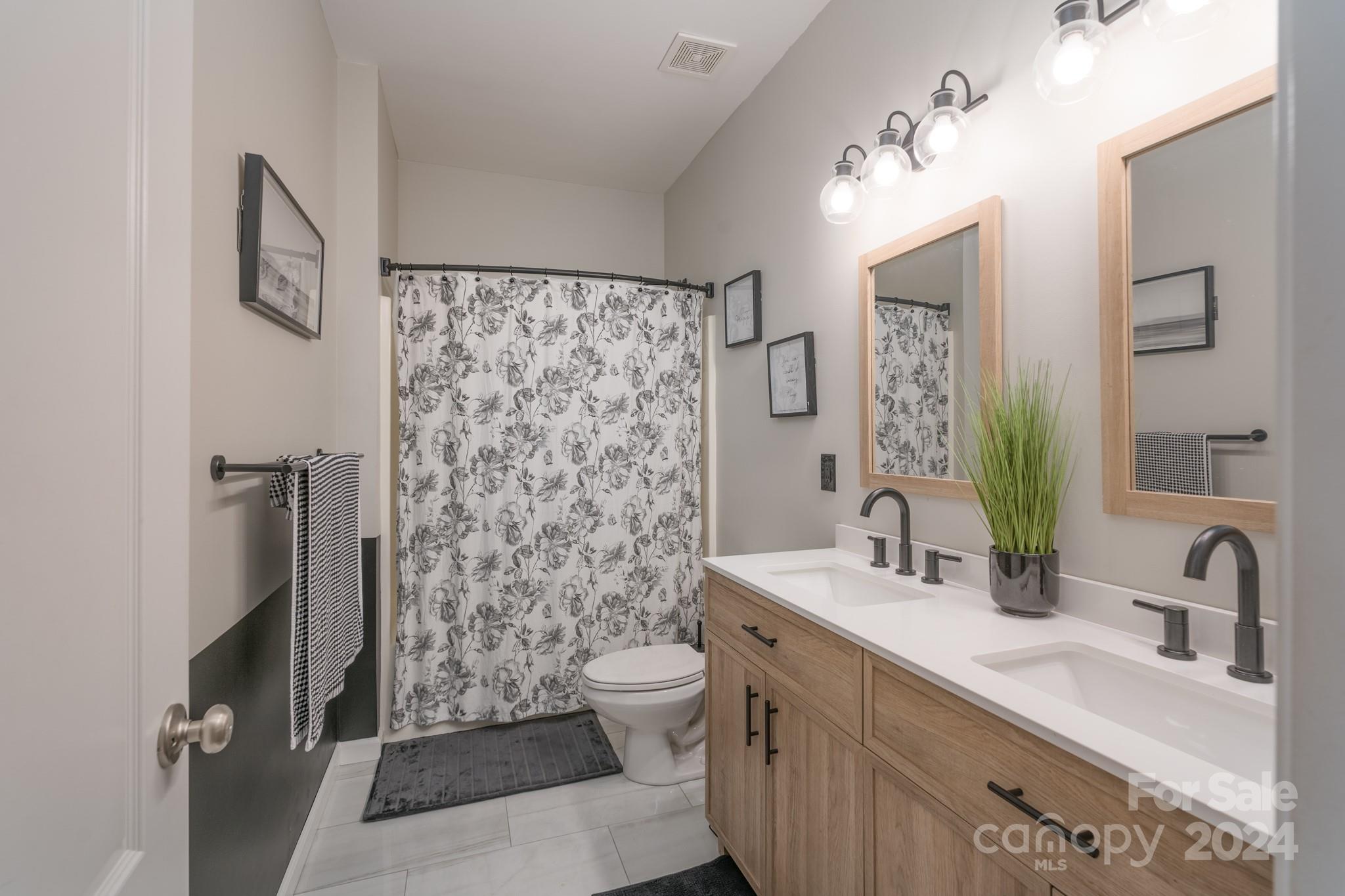 925 Treasure Court Fort Mill, SC 29708 - Photo 24 of 45 a bathroom with a sink a toilet and shower