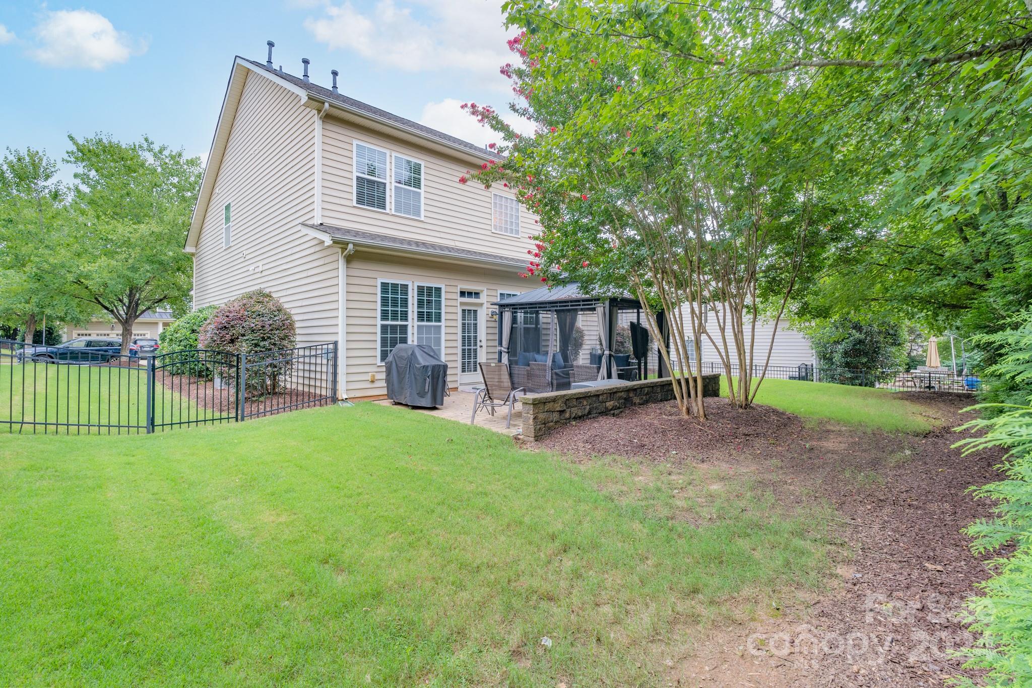 925 Treasure Court Fort Mill, SC 29708 - Photo 34 of 45 a view of a house with backyard and a tree