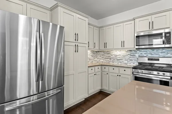 a kitchen with stainless steel appliances granite countertop a refrigerator sink and stove