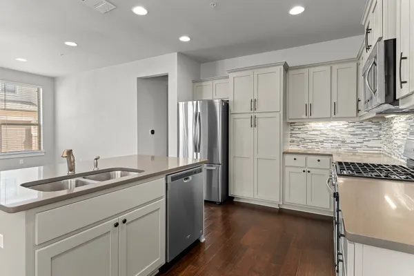 a kitchen with appliances cabinets and a sink
