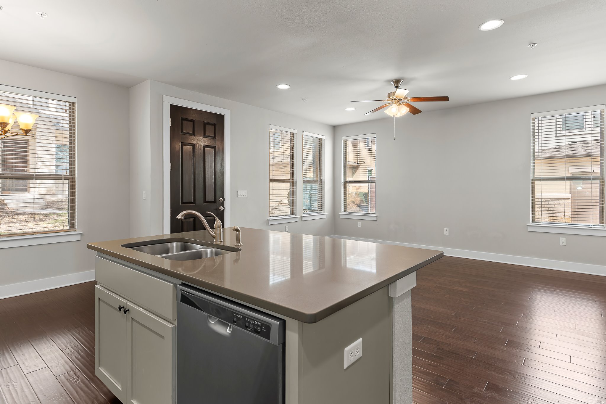 13800 Lyndhurst Street, Unit 211 Austin, TX 78717 - Photo 15 of 40 Kitchen featuring dishwasher, an island with sink, dark wood-style floors, healthy amount of natural light, and recessed lighting