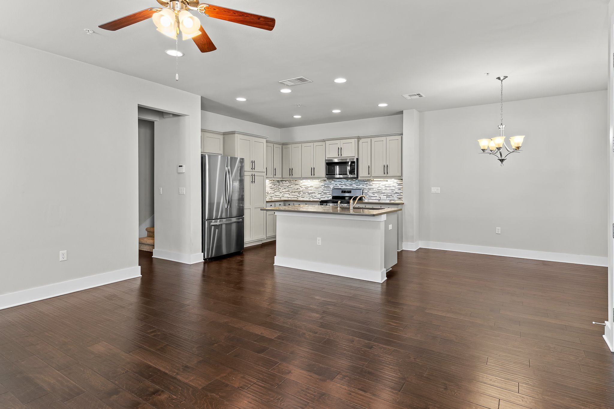 13800 Lyndhurst Street, Unit 211 Austin, TX 78717 - Photo 39 of 40 Kitchen featuring stainless steel appliances, open floor plan, and a kitchen island with sink