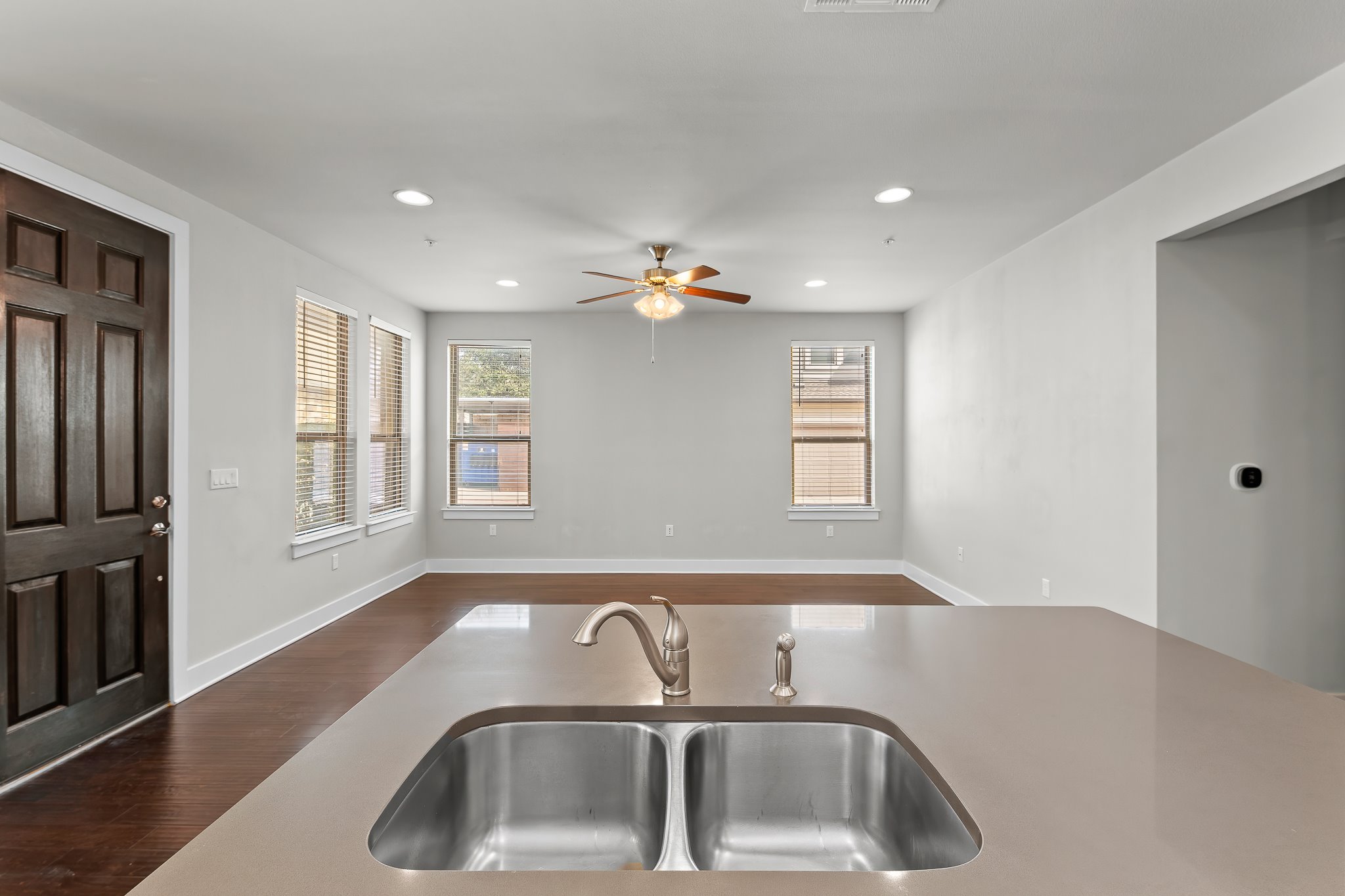 13800 Lyndhurst Street, Unit 211 Austin, TX 78717 - Photo 40 of 40 Kitchen featuring dark wood-style floors, healthy amount of natural light, recessed lighting, and open floor plan