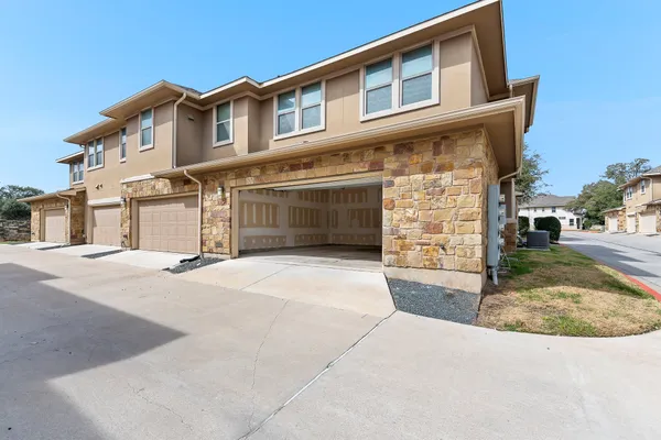 a spacious bathroom with a granite countertop double vanity sink a mirror and shower