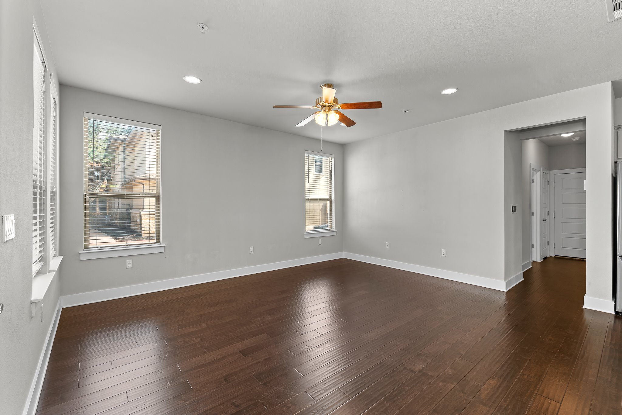 13800 Lyndhurst Street, Unit 211 Austin, TX 78717 - Photo 4 of 40 Living room with a ceiling fan, dark wood finished floors, and recessed lighting