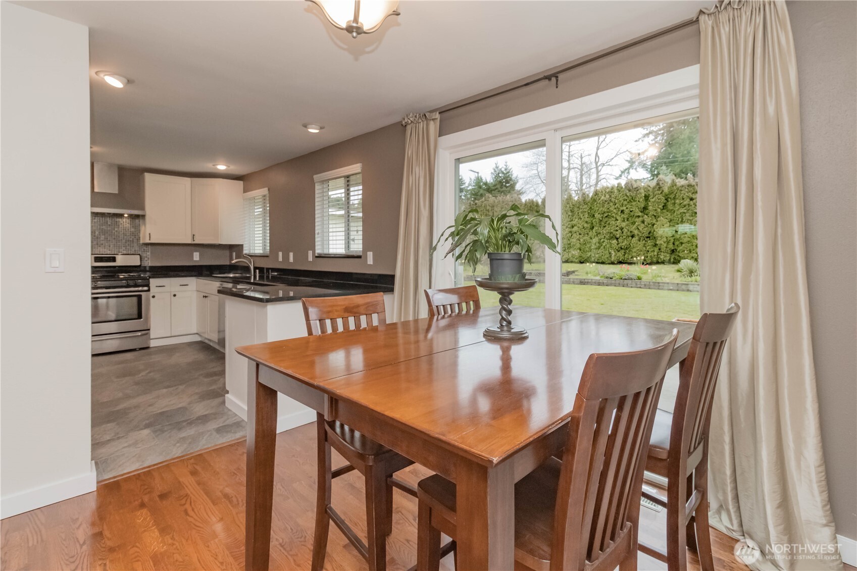 1060 Lynnwood Avenue Northeast Renton, WA 98056 - Photo 11 of 40 a kitchen with a table chairs stove and cabinets
