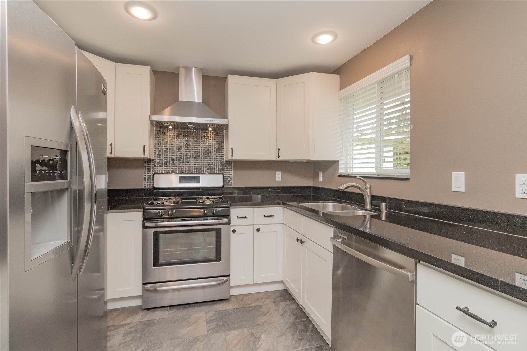 1060 Lynnwood Avenue Northeast Renton, WA 98056 - Photo 15 of 40 a kitchen with stainless steel appliances granite countertop a sink stove and refrigerator