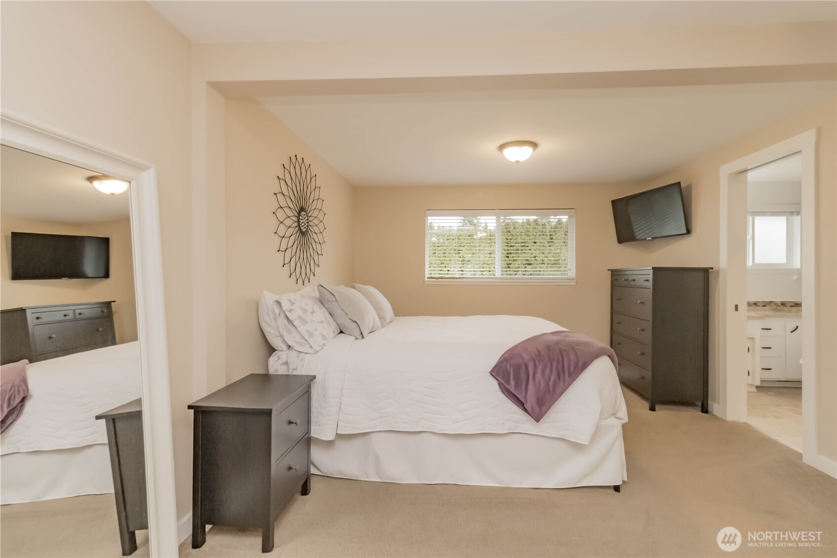 1060 Lynnwood Avenue Northeast Renton, WA 98056 - Photo 20 of 40 a bedroom with a large bed and a flat tv screen on dresser