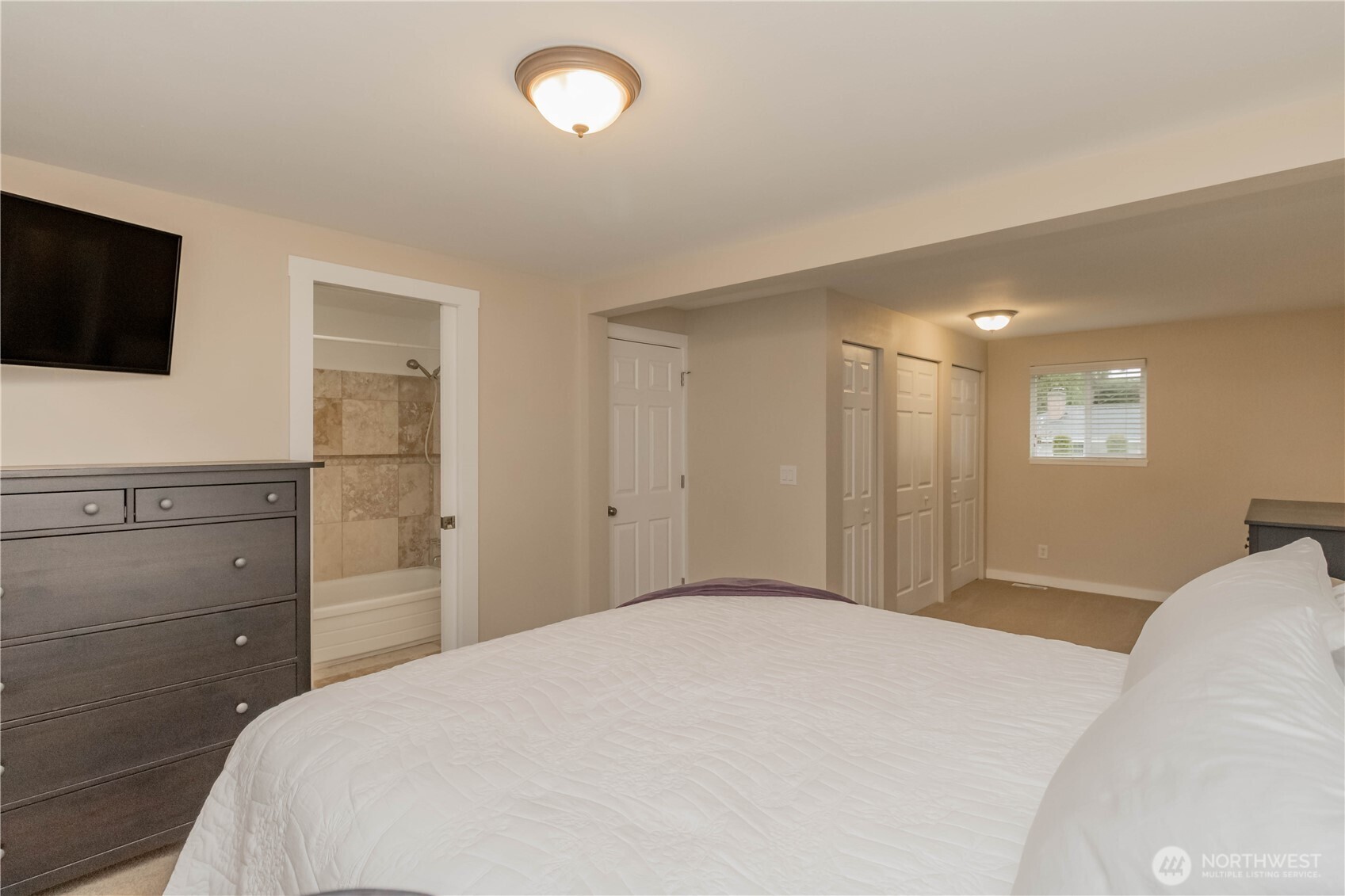 1060 Lynnwood Avenue Northeast Renton, WA 98056 - Photo 23 of 40 a bedroom with a bed and a flat screen tv
